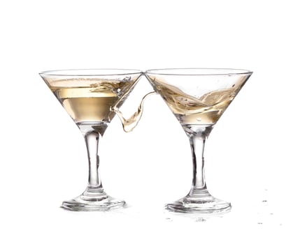 two wine swirling in a goblet martini glass, isolated on a white background photo