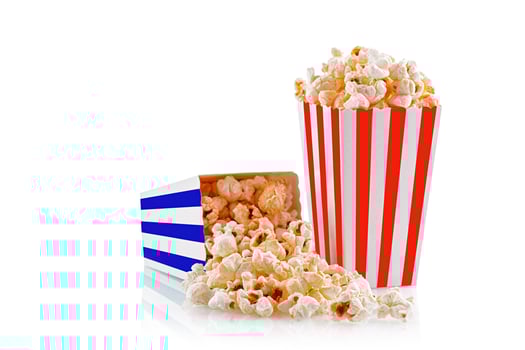 Glass with popcorn on a white background photo