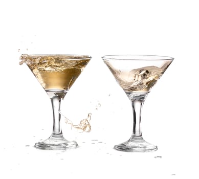 two wine swirling in a goblet martini glass, isolated on a white background photo