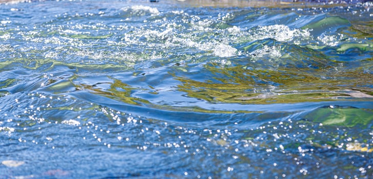 flow of water and spray from a stone photo