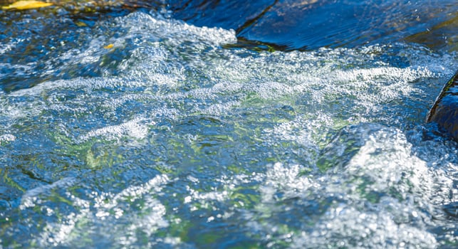 flow of water and spray from a stone photo