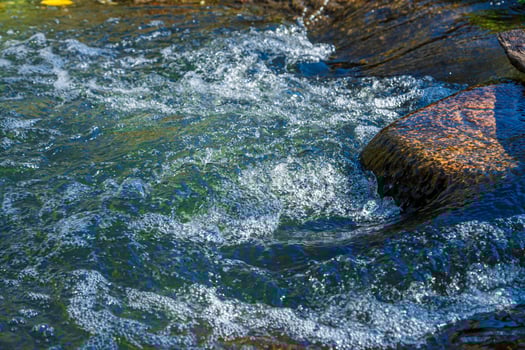 flow of water and spray from a stone photo