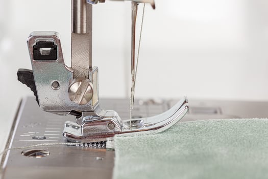 Sewing machine, stitching fabrics, needle in a round plan photo