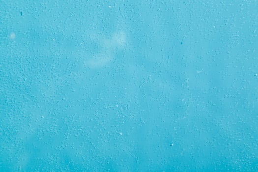 drops on water with circles on a blue background photo