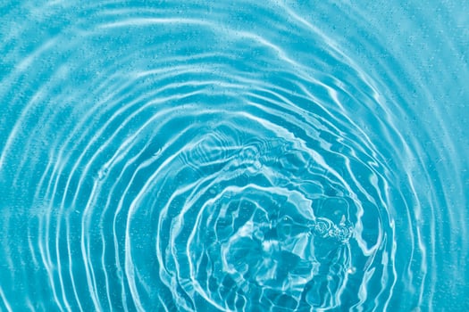drops on water with circles on a blue background photo