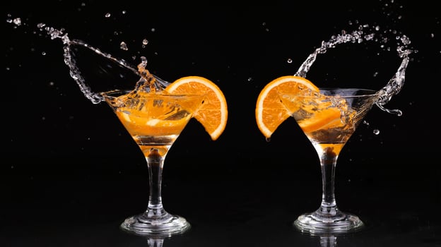 Two glasses with orange slices and water splashing photo