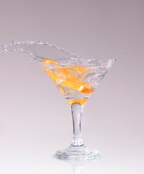 cocktail in a martini glass on a white background with fruit photo