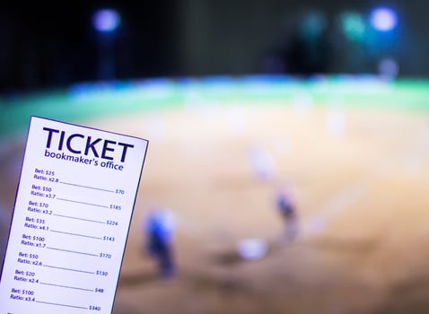 Bookmaker ticket on the background of the TV on which show a sports game softball, sports betting, softball photo