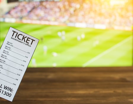 Bookmaker ticket on the background of TV on which show Gaelic football, sports betting, bookmaker photo