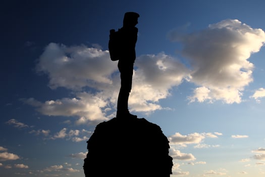 man at the top of the mountain photo