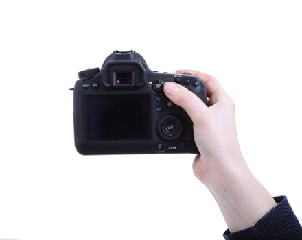 A person holding a digital camera with a white background photo