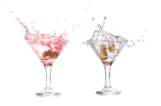 Splash from olive in a glass of cocktail, isolated on the white background, clipping path included. photo