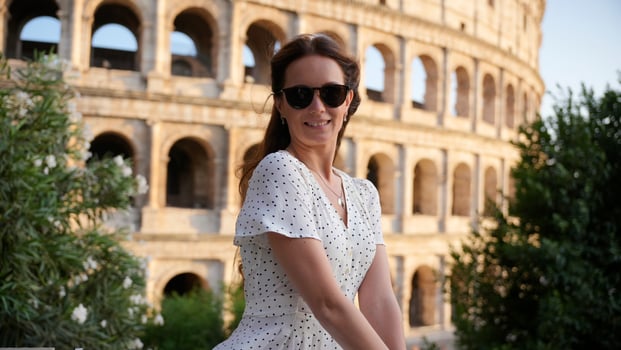 Happy traveler in sunglasses exploring Romes Colosseum on a sunny day in Italy photo