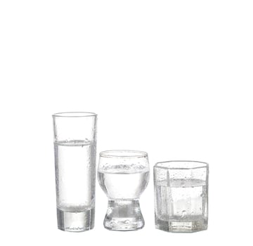 Bottle of vodka and wineglass isolated on white photo