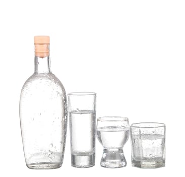 Bottle of vodka and wineglass isolated on white photo