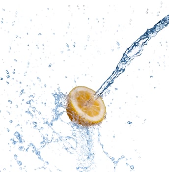 segment of lemon falling in to the water and making splash photo