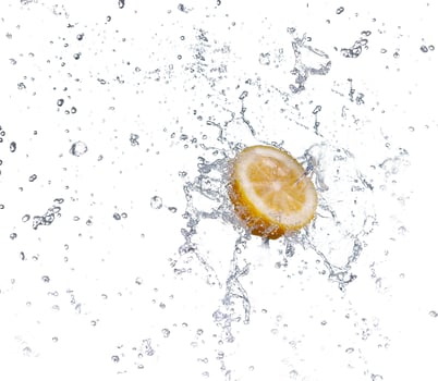 segment of lemon falling in to the water and making splash photo