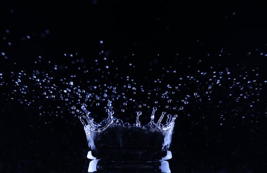 brilliant drops transparent water on black background photo
