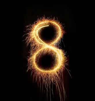 burning sparkler stick and writing sparkling text . photo