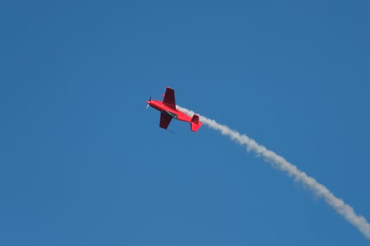 Stunt aerobatic plane performing stunts in air photo