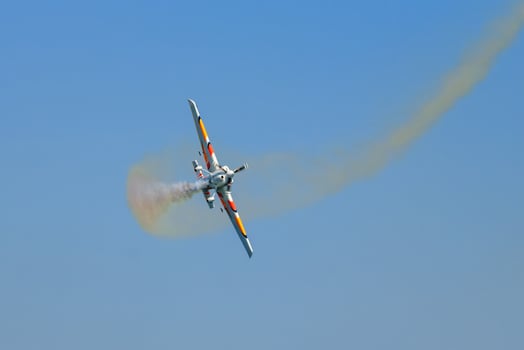 Stunt aerobatic plane performing stunts in air photo
