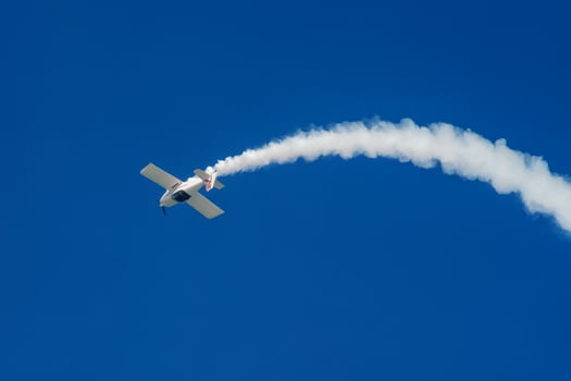 Stunt aerobatic plane performing stunts in air photo