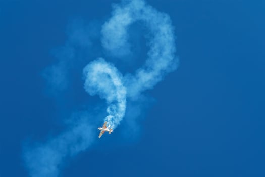 Stunt aerobatic plane performing stunts in air photo