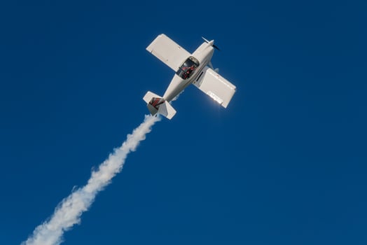 Stunt aerobatic plane performing stunts in air photo