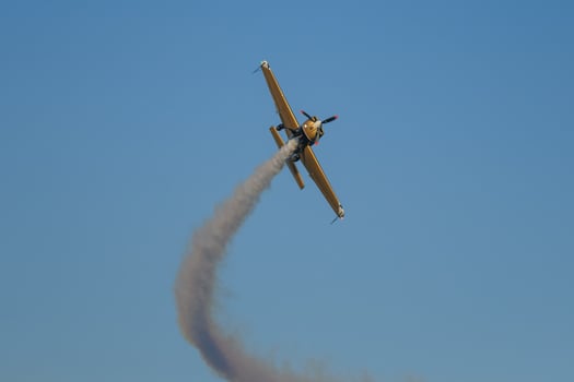 Stunt aerobatic plane performing stunts in air photo
