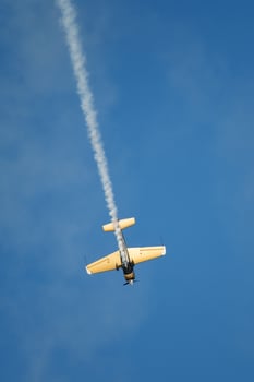 Stunt aerobatic plane performing stunts in air photo