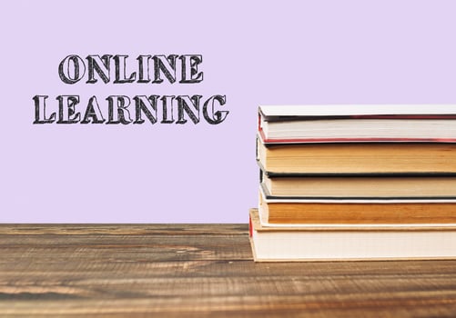 Stack of books with the word online learning written on top photo
