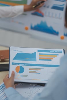 A group of people looking at graphs and charts photo
