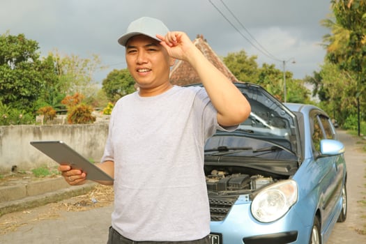 Professional car mechanic maintenance vehicle. The mechanic opens the front of the car. Checking the broken engine. Check the damage as listed. Repair car outside service. photo