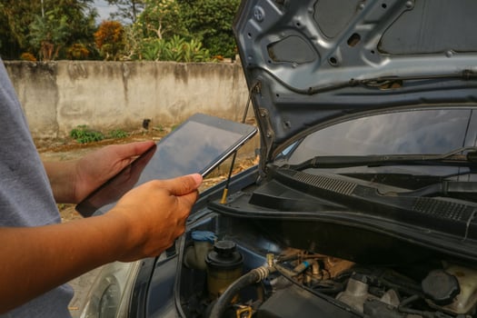 Asian men maintenance checking car service via insurance system at garage with using tablet photo