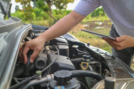Professional car mechanic maintenance vehicle. The mechanic opens the front of the car. Checking the broken engine. Check the damage as listed. Repair car outside service. photo