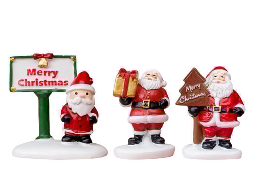 Miniature Santa Claus figurine isolated on a white background with a clipping path photo
