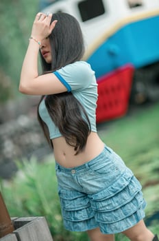 A woman in a blue shirt and blue shorts photo