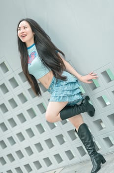 A woman in a blue shirt and skirt posing photo