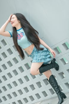 A woman in a blue shirt and skirt photo