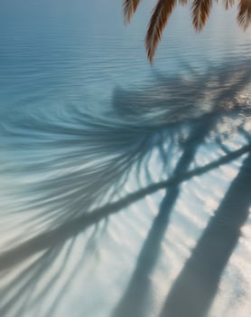 Tranquil Blue Water Surface with Palm Tree Shadows and Sunlight Reflections. photo