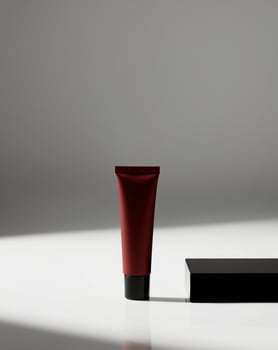 a matte red cosmetic tube standing on a blank black background. photo
