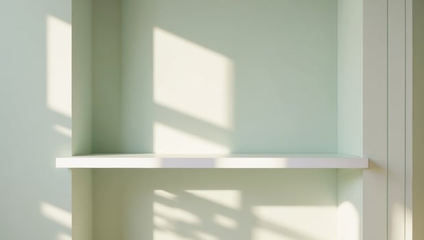 there is a white shelf near a light green wall there's nothing on the shelf. photo