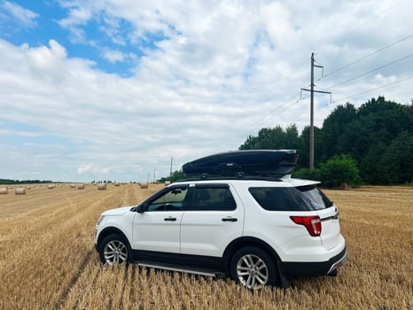 Kyiv, Ukraine - November 22, 2024 White Ford Explorer SUV parked in a scenic rural landscape photo
