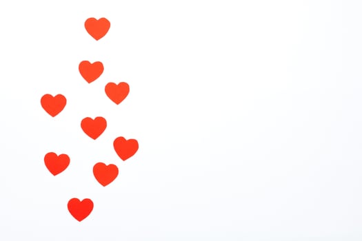 Red hearts made of paper on a white background. Top view. Valentine's Day. Symbol of love. photo