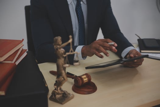 A lawyer using a tablet in his office photo