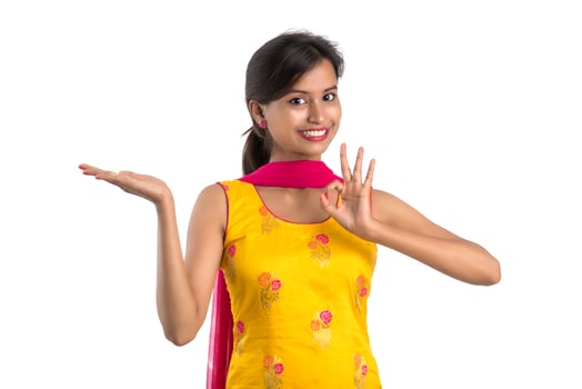 Beautiful girl holding and presenting something on the hand with happy smiling. photo