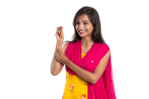 Beautiful Indian girl showing Rakhis on occasion of Raksha bandhan. Sister tie Rakhi as symbol of intense love for her brother. photo