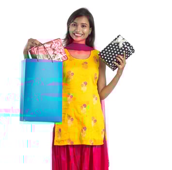A beautiful woman posing with a shopping bag and gift Boxes on a white background. photo
