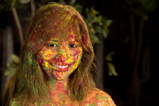 Portrait of a happy young girl on the festival of colors Holi. Girl posing and celebrating the festival of colors. photo