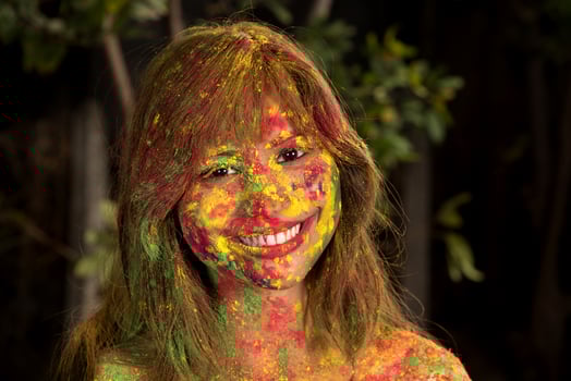 Portrait of a happy young girl on the festival of colors Holi. Girl posing and celebrating the festival of colors. photo